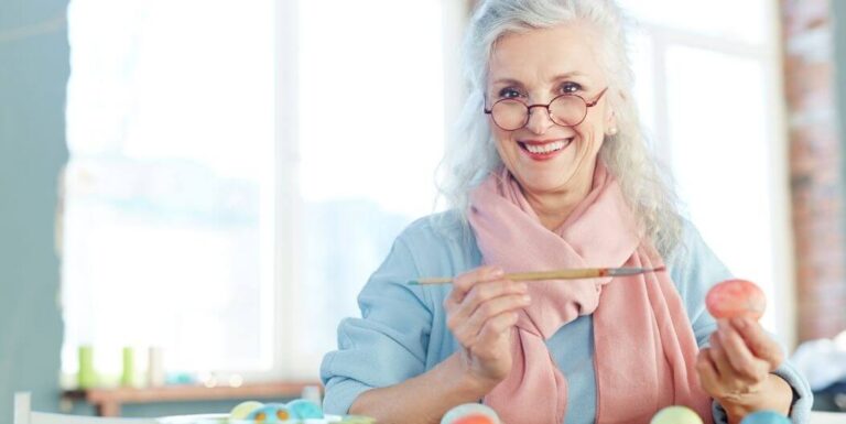 Elderly Woman Painting Eggs as Hobby at Independent Living Facility